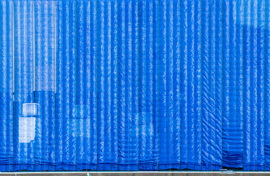 Blue Sunshade Net with Textured Wrinkles and White Truck Underne
