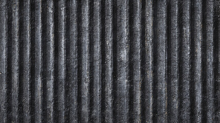 Close-up of a textured corrugated metal surface, exhibiting vertical lines and a gritty appearance