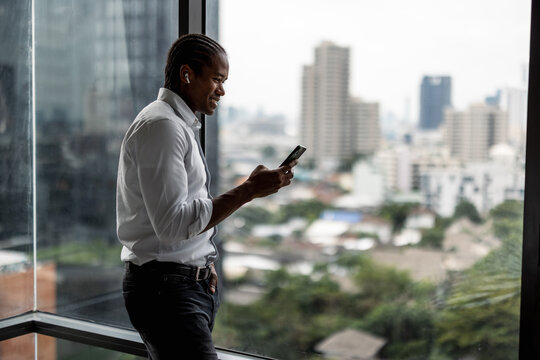 Professional Man In White Shirt Using Smartphone While Standing 