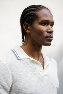 Portrait Of A Man With Cornrowed Hair In White Knit Polo Shirt