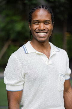 Smiling Man In White Textured Polo Shirt Outdoors 