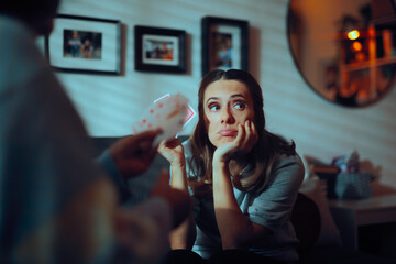 Bored Woman Playing Cards with a Friend. Lady being a sore loser during game night with friends 
