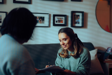 Woman Signing some Documents at Home on the Couch. Lady reading and signing power of attorney paperwork 