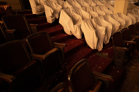 Covered and Damaged Pews in Dim Light