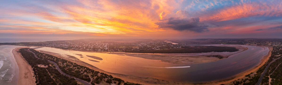 Colorful sunset over coastal river mouth