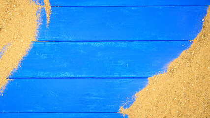 Sand on blue wooden. Sea summer vacation background with space for the text. Top view