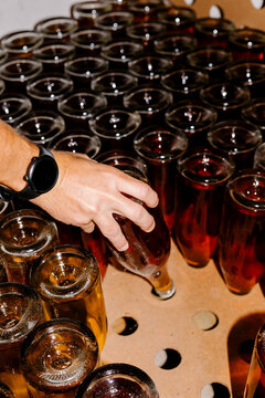 Unidentified hand organizing freshly bottled wine