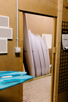 Unfinished surfboards positioned in a workshop storage area