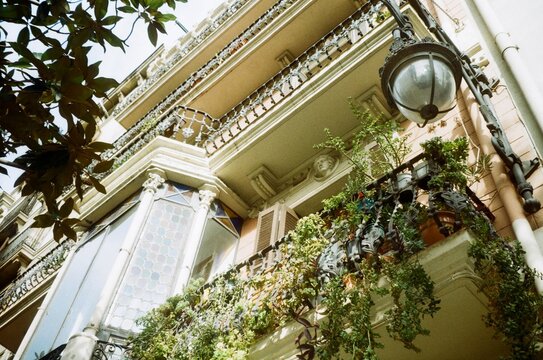 Ornate Barcelona Modernist Balcony with Plants and Lantern
