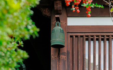 An Ancient Bronze Bell Under the Eaves of a Buddhist Temple.
