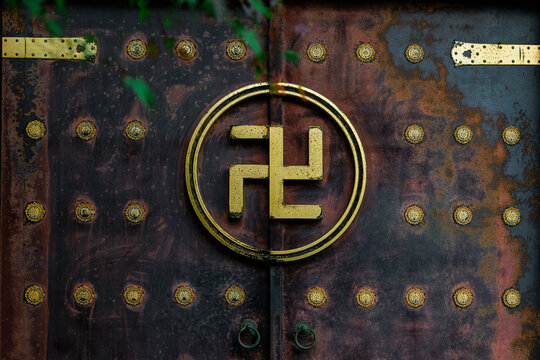 Oriental Charm: The Swastika Symbol on a Patina Temple Gate.