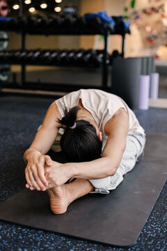 Asian Man Warming up for Climbing Session 
