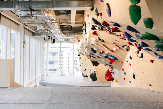 Indoor Rock Climbing Gym With Colorful Holds And Large Windows