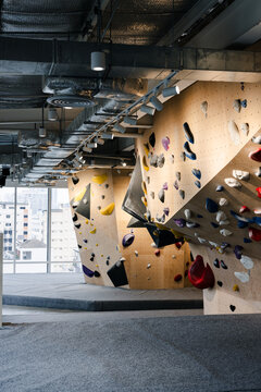 Indoor Bouldering Gym With Colorful Holds And Wooden Walls