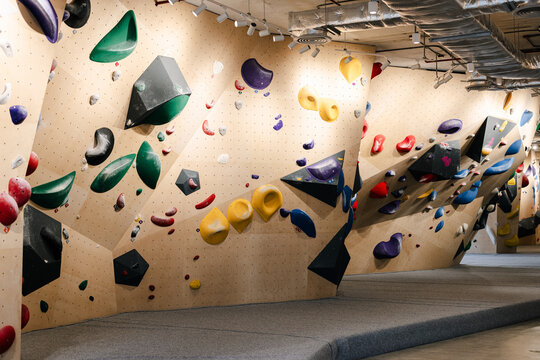 Indoor Bouldering Gym With Colorful Climbing Holds and Slanted Walls