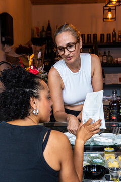 Businesswoman explains a coffee product to a customer 