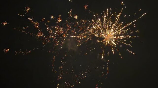 Golden fireworks in the night sky: spectacular lighting effects at a celebration