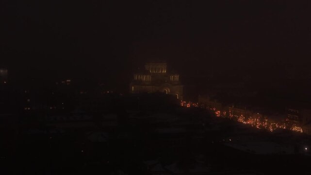 Church of St. Michael the Archangel on foggy Christmas night, aerial view