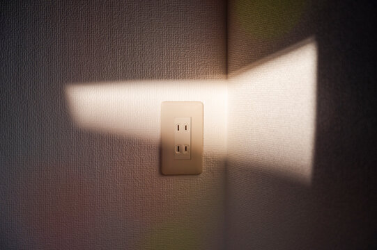 Sunlight on wall with empty power outlet