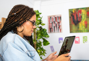 Young woman video conferencing with a friend on ipad