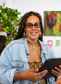 Fashionable smiling woman holds a tablet