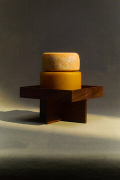 Still life of cheeses on a pedestal