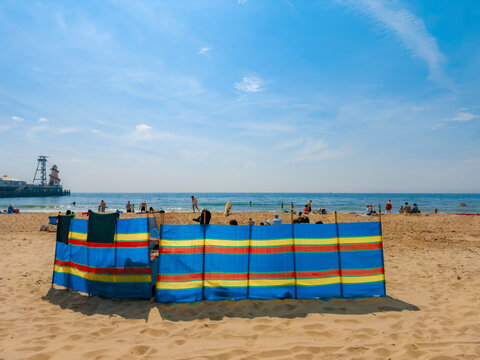 Bright Beach Scene With Colorful Windbreaks on a Sunny Day