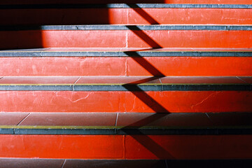 Film photo of red staircase with shadowy patterns