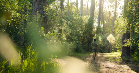 Fitness, back and man in forest with running, cardio and stamina training in sport challenge. Exercise, wellness and athlete in nature with jog, outdoor trail and endurance workout in Costa Rica. © BuyOutFelix06/peopleimages.com