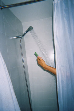 checking his phone under running water in the shower, 35mm film