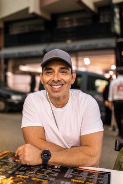 Man sitting at restaurant table smiling at camera in Tangier