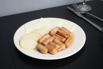 Cheese platter with sausage on white plate tray as Christmas festive holiday or thanksgiving food. Blank background mockup with copy space for adding text, logo, product, or promotional design.