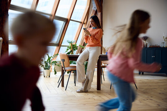 Woman uses her phone in the dining room