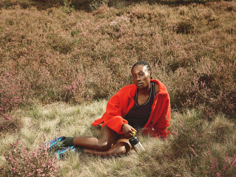 Black Woman Hiking in Red Fleece in Autumn Field