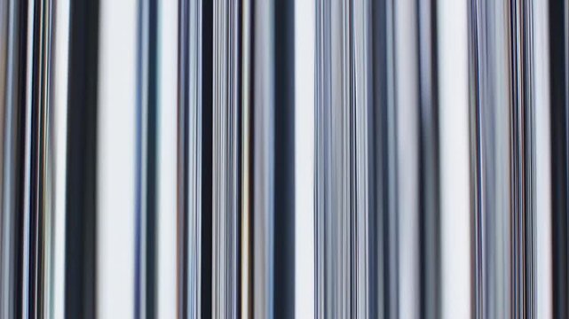 Vertical, blurred close-up of parallel, gradient-filled lines in shades of gray, white, and blue