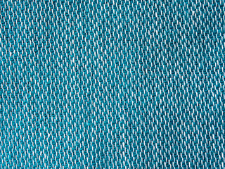 Green woven fabric threads closeup background. Green carpet fragments. Turquoise and white woven...