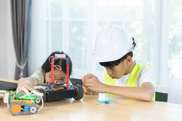 Kids boy and girl working together on robotics project, combining programming, engineering skills, promoting STEM education, teamwork, creativity, learning for future innovation.
