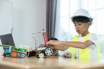 Kids boy and girl working together on robotics project, combining programming, engineering skills, promoting STEM education, teamwork, creativity, learning for future innovation.