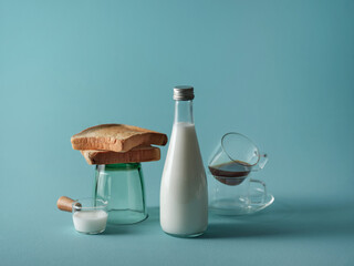 Breakfast still life with toast, milk, coffee, and a teal background