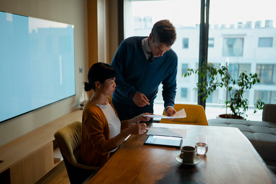 Business colleagues collaborating on documents in modern office
