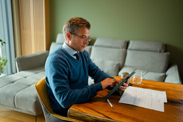 Mature man working with tablet from home office
