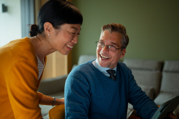 Diverse couple discussing finance on a digital tablet at home
