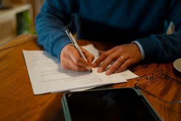 Person signing important document, preparing contract and paperwork
