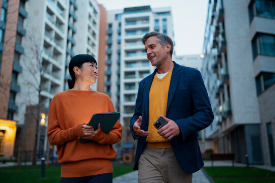 Business colleagues walking and discussing real estate