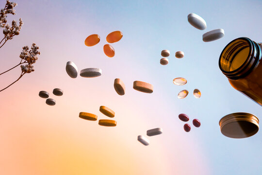 Variety Of Colorful Pills And Vitamins in Colorful Background