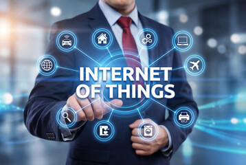 Businessman using Internet of Things technology with virtual interface icons, smart connected devices, digital network system, modern business innovation, data connectivity and automation concept.