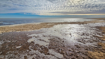 Lake Eyre dry salt flat landscape with cloudy blue sky