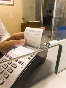 Woman showing a failed card payment at the bus station