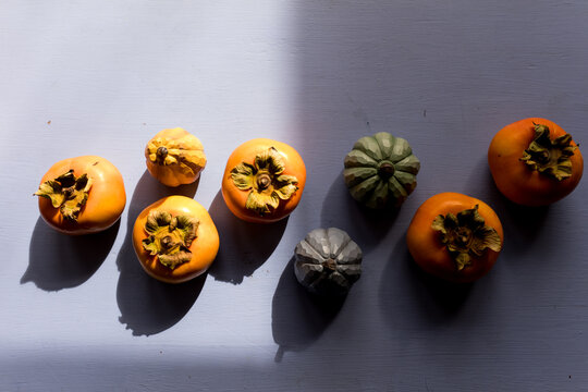 Colorful Collection of Persimmons and Gourds Arranged Artistically