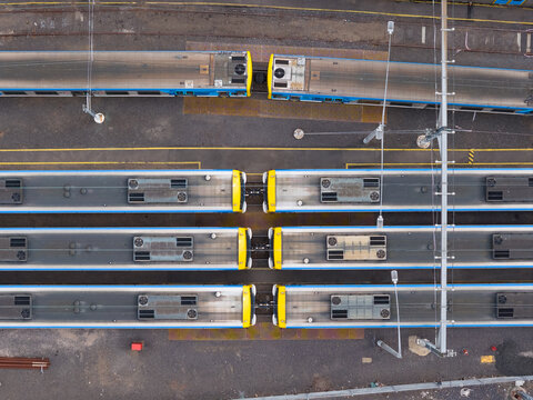 Commuter trains lined up in a city railyard